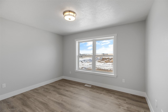 unfurnished room with light hardwood / wood-style flooring