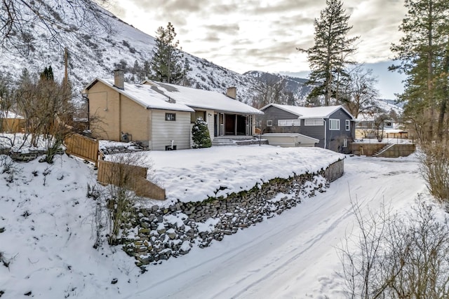 yard covered in snow with a mountain view