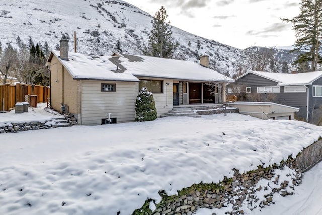 snow covered property with a mountain view