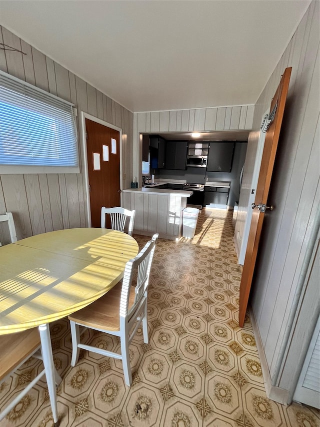 dining area featuring wood walls