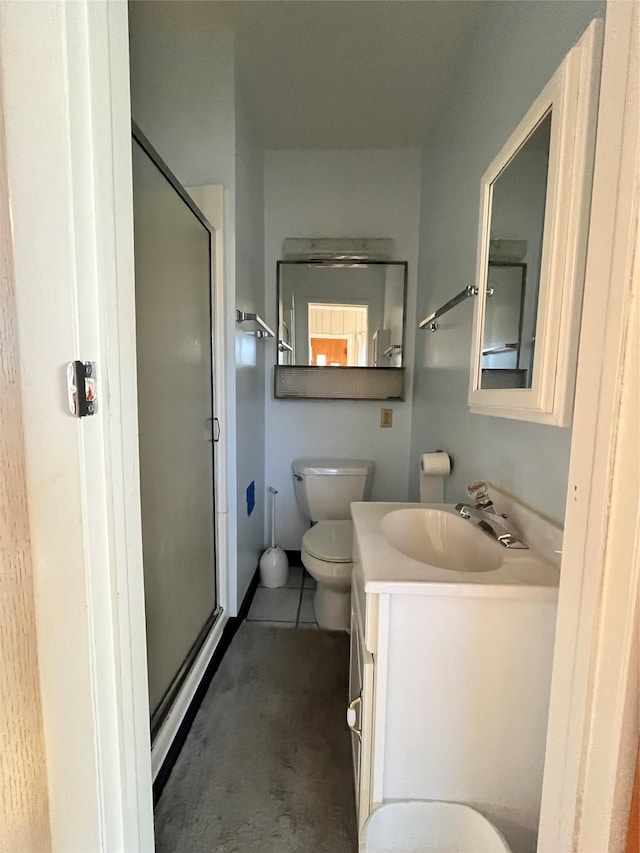 bathroom with an enclosed shower, vanity, concrete flooring, and toilet