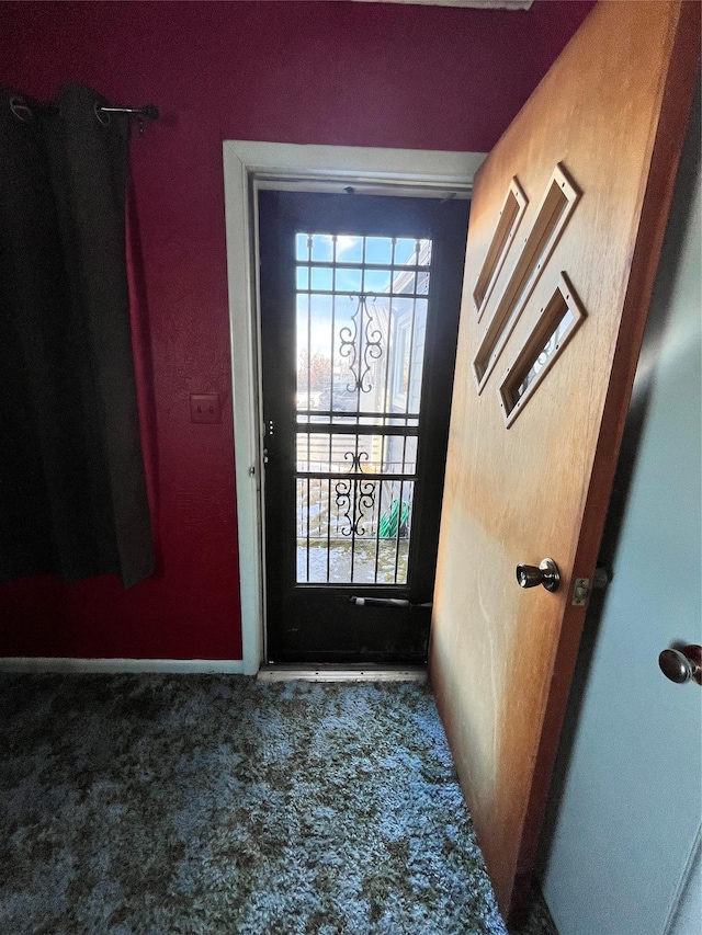 entryway with a wealth of natural light and carpet