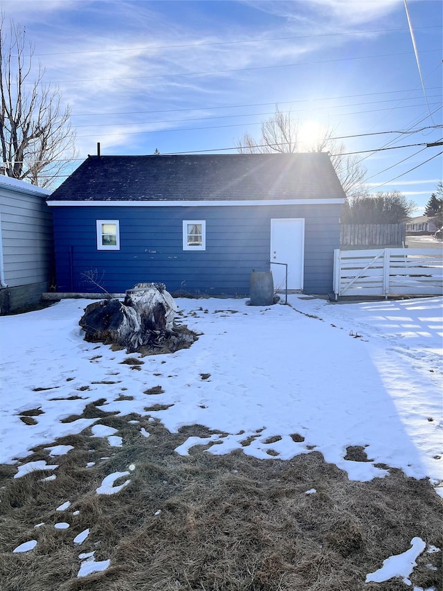 view of snow covered rear of property