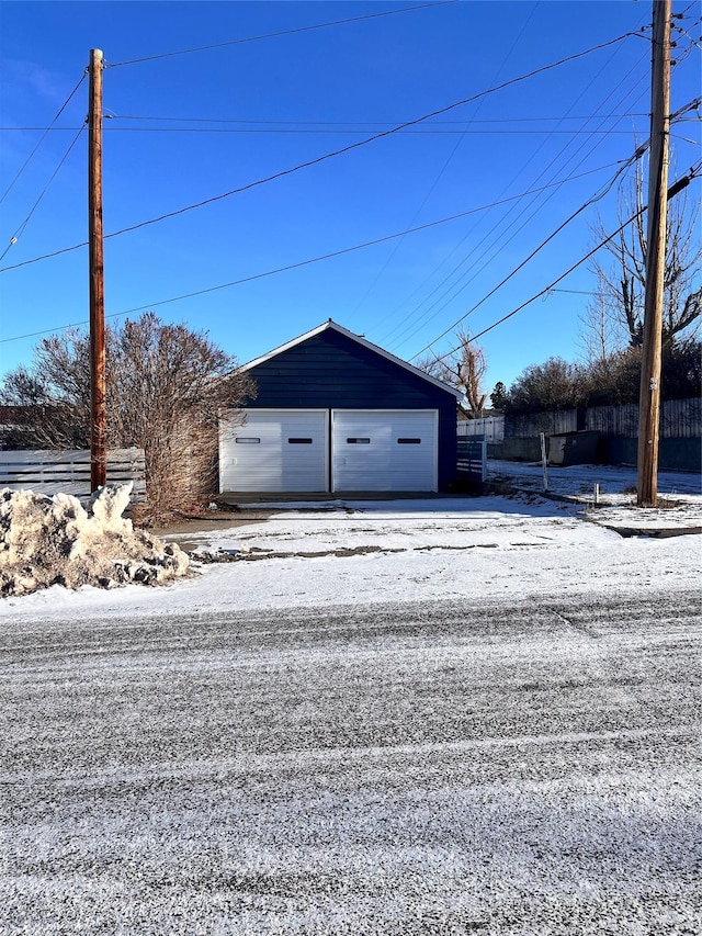 exterior space with a garage and an outdoor structure