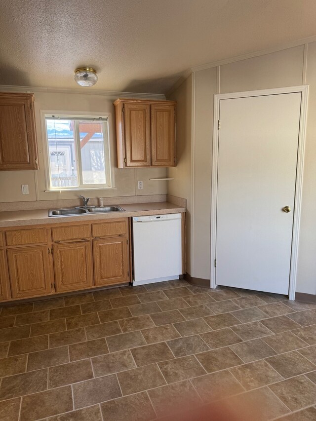kitchen with light countertops, dishwasher, a sink, and brown cabinetry
