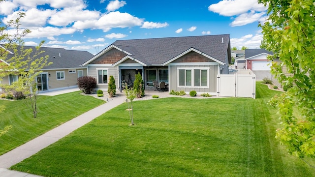 view of front of house with a patio area and a front lawn