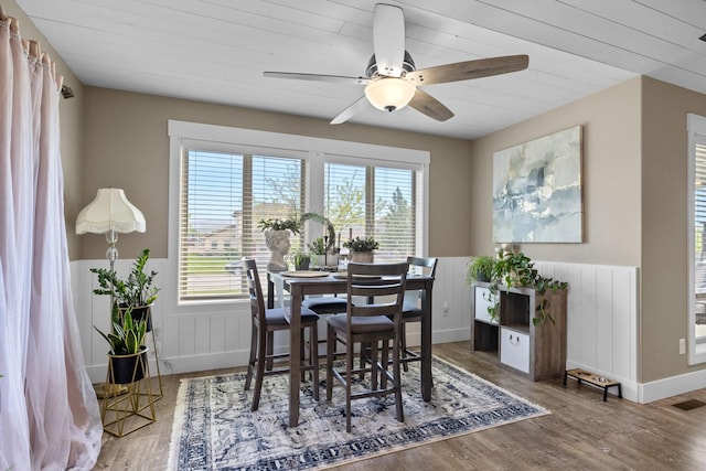 dining space featuring hardwood / wood-style floors, radiator heating unit, wooden ceiling, and ceiling fan