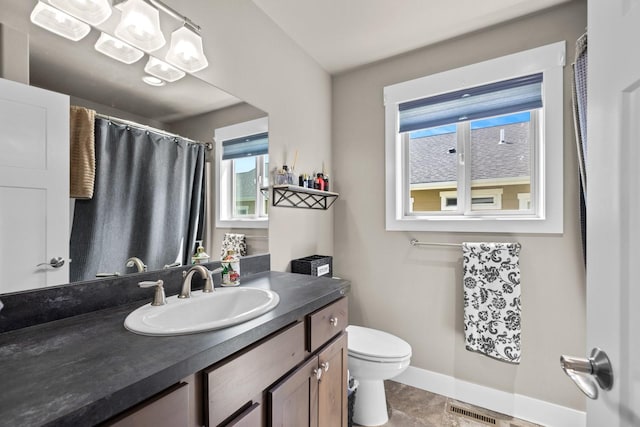 bathroom featuring vanity and toilet