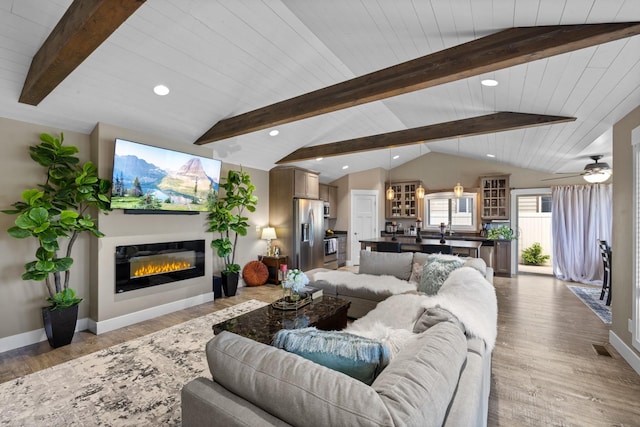 living room featuring lofted ceiling with beams, ceiling fan, wooden ceiling, and light hardwood / wood-style floors