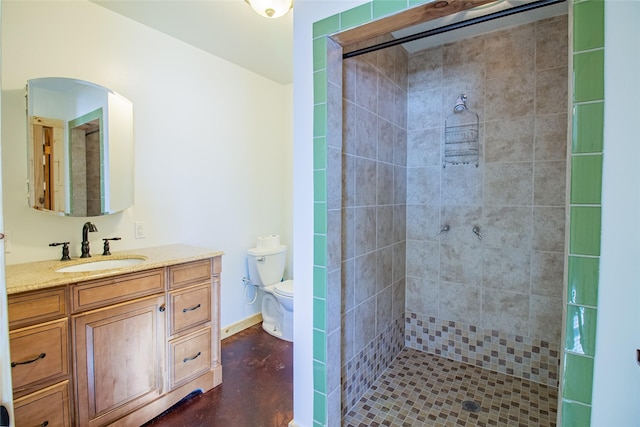 full bath with vanity, baseboards, a stall shower, concrete flooring, and toilet