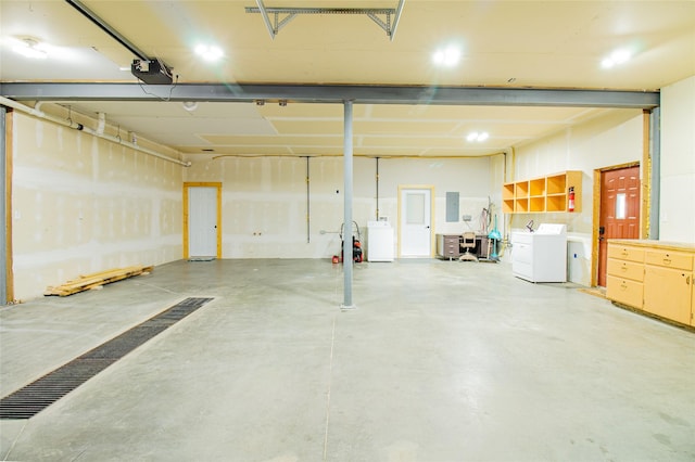 garage with a garage door opener and washing machine and clothes dryer