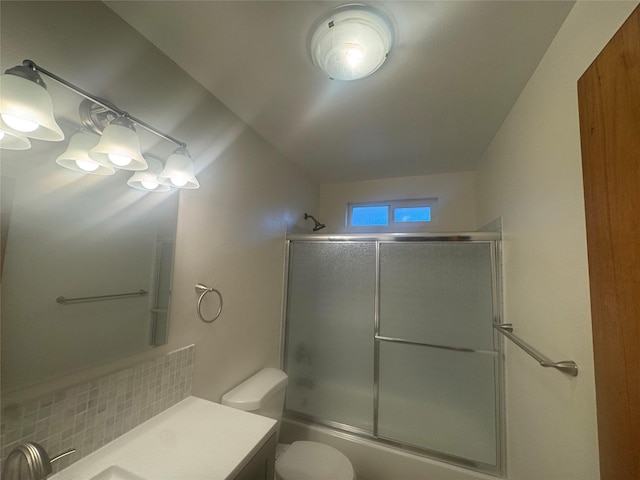 full bathroom featuring toilet, vanity, bath / shower combo with glass door, and decorative backsplash