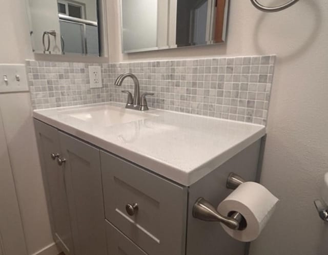 bathroom with vanity and backsplash