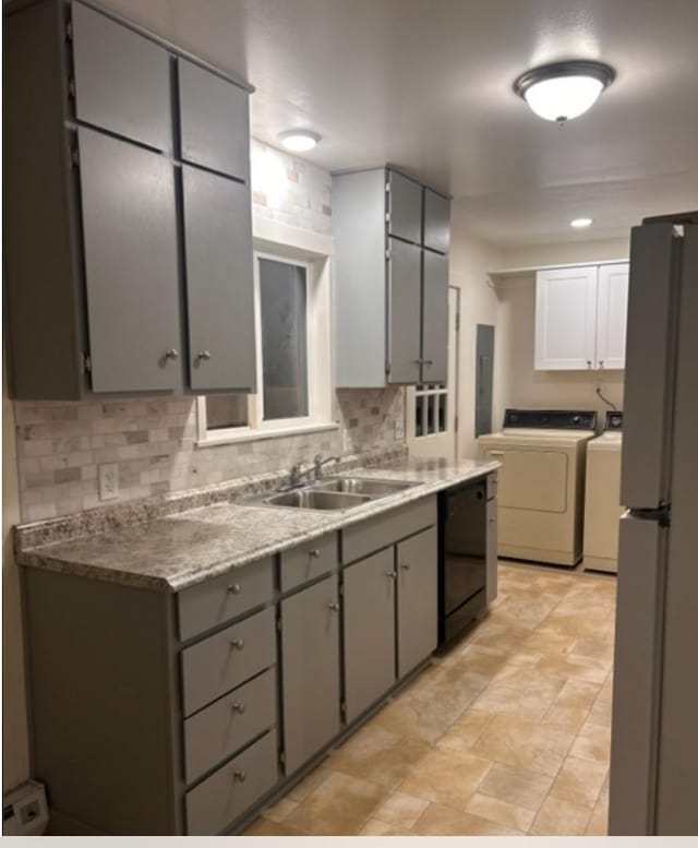 kitchen with sink, dishwasher, refrigerator, gray cabinetry, and washer and dryer