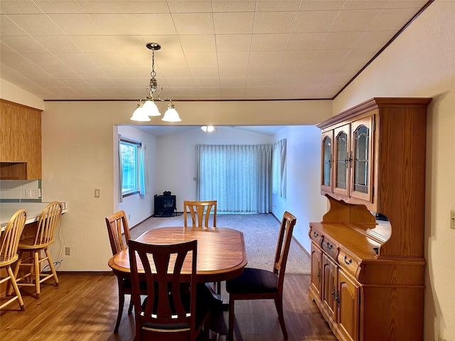 dining area featuring dark wood-type flooring and ornamental molding