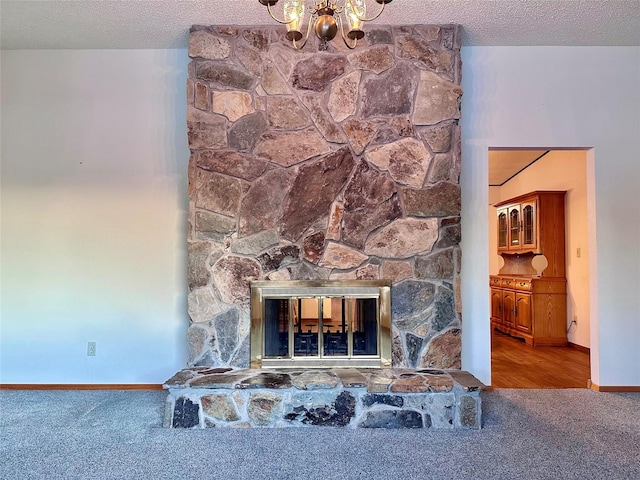 details featuring carpet flooring, a fireplace, and a textured ceiling