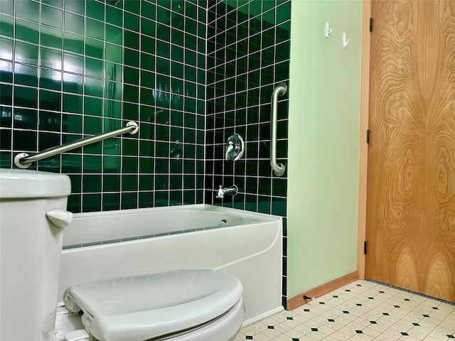 bathroom with tiled shower / bath combo and toilet