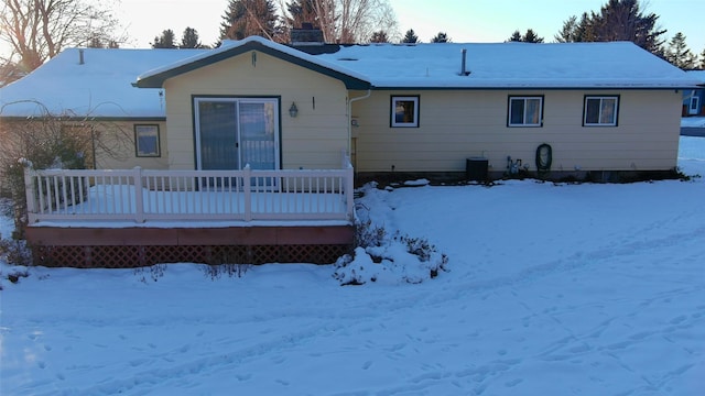 view of snow covered back of property