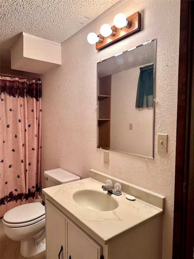 bathroom with a shower with curtain, vanity, a textured ceiling, and toilet