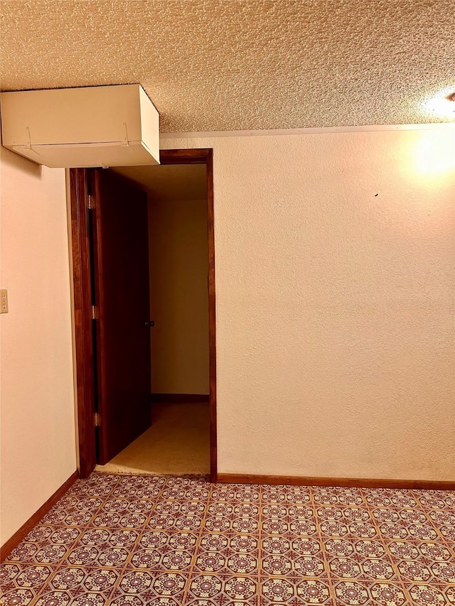 unfurnished room with a textured ceiling