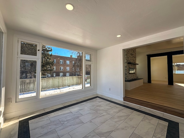 unfurnished dining area with a fireplace