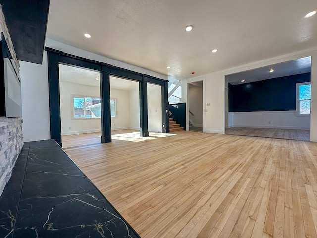 living room featuring plenty of natural light and light hardwood / wood-style floors