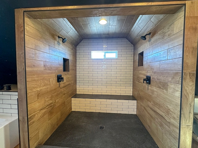 bathroom featuring lofted ceiling, a tile shower, and wooden ceiling