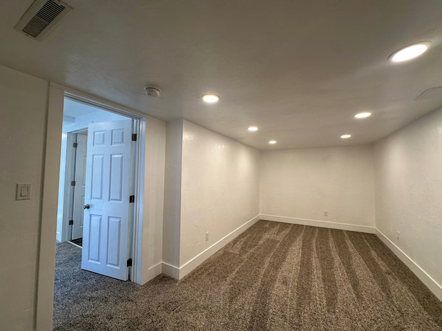 unfurnished room featuring dark carpet