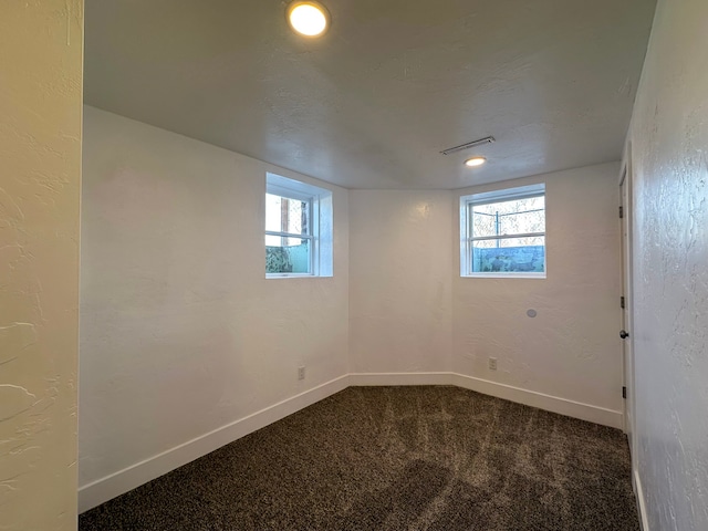 basement featuring carpet and a textured ceiling