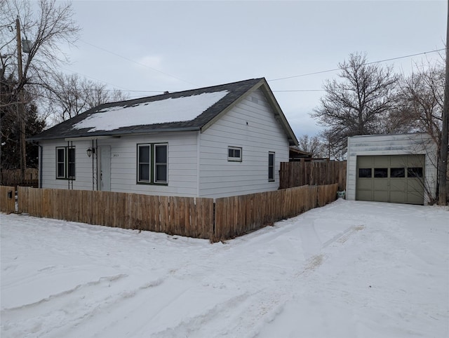 view of front of home featuring a garage and an outdoor structure