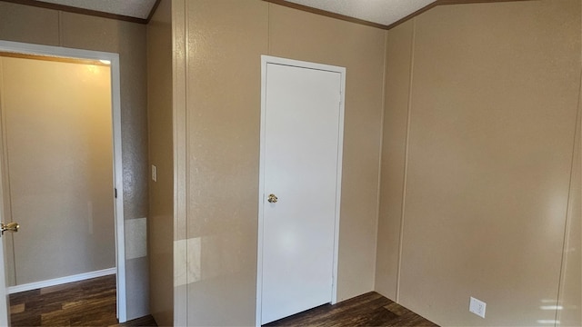 spare room with ornamental molding, dark hardwood / wood-style flooring, and a textured ceiling