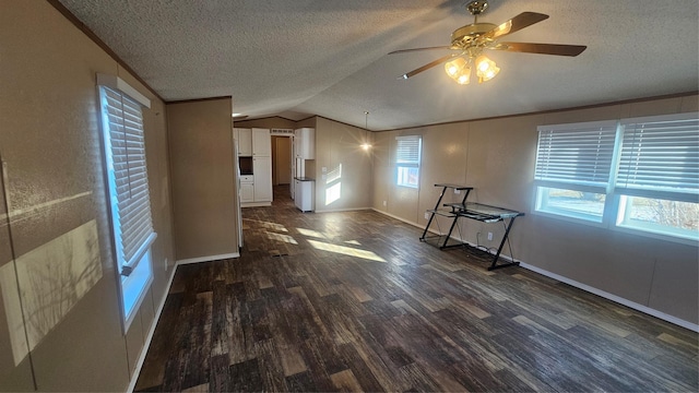 unfurnished living room with ceiling fan, lofted ceiling, dark wood-type flooring, and a textured ceiling