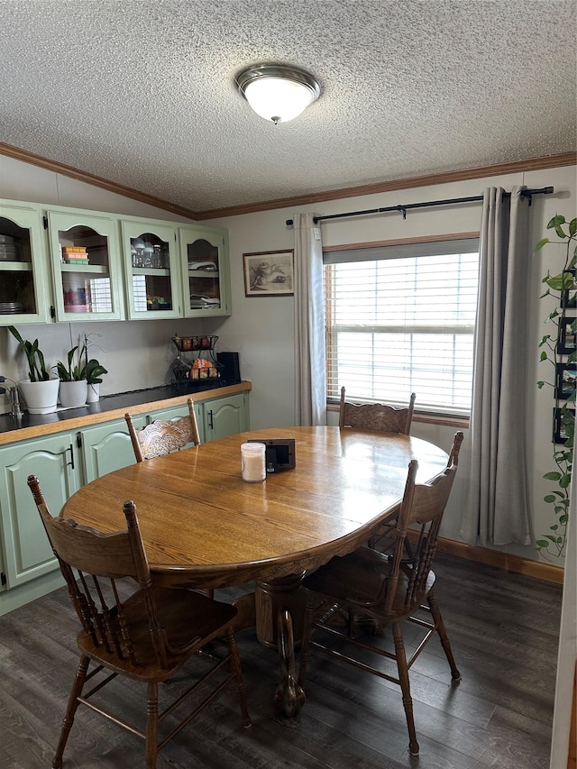 dining room featuring ornamental molding, a textured ceiling, and dark hardwood / wood-style flooring