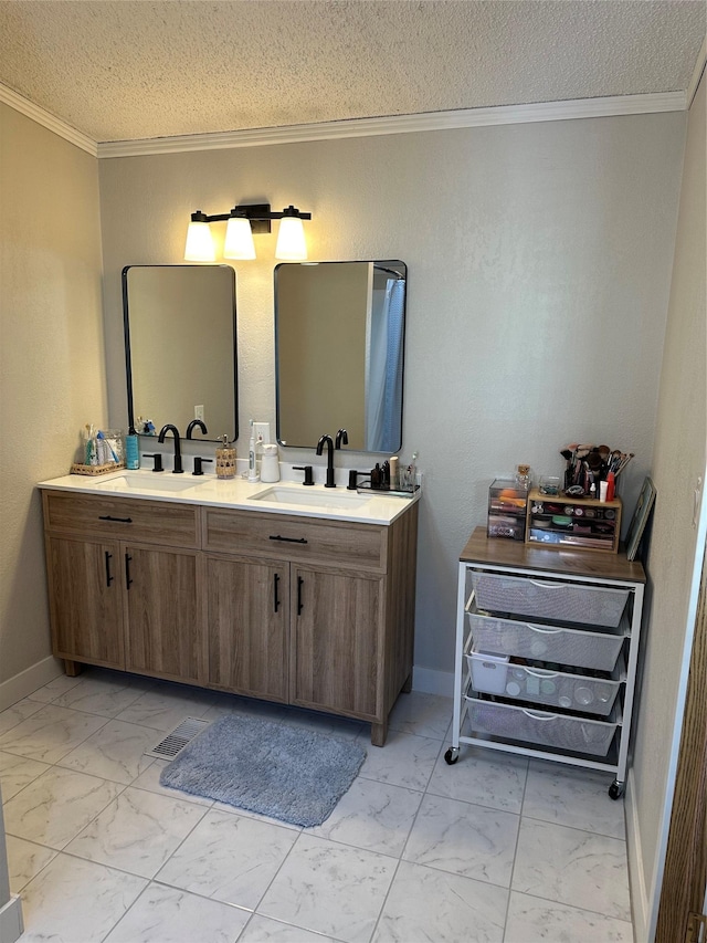 bathroom with ornamental molding, a textured ceiling, and vanity