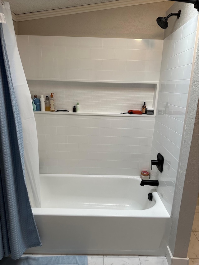 bathroom featuring ornamental molding and shower / bath combo with shower curtain