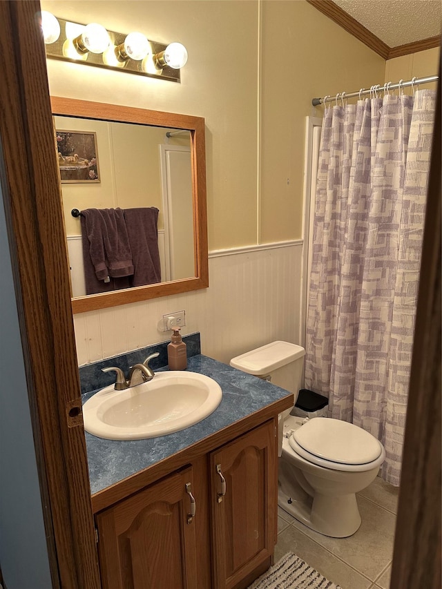 bathroom featuring crown molding, tile patterned flooring, vanity, a textured ceiling, and toilet