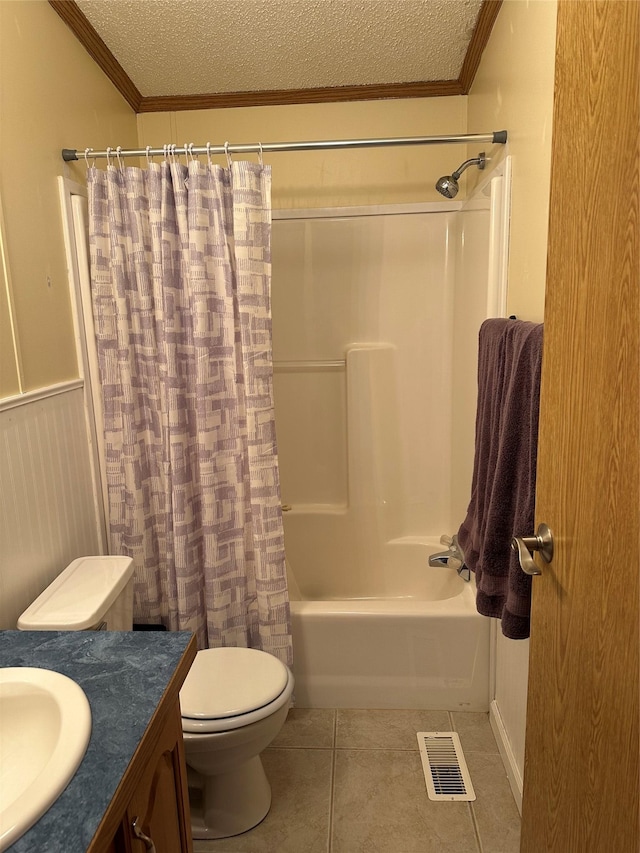 full bathroom with shower / tub combo with curtain, tile patterned floors, toilet, a textured ceiling, and ornamental molding