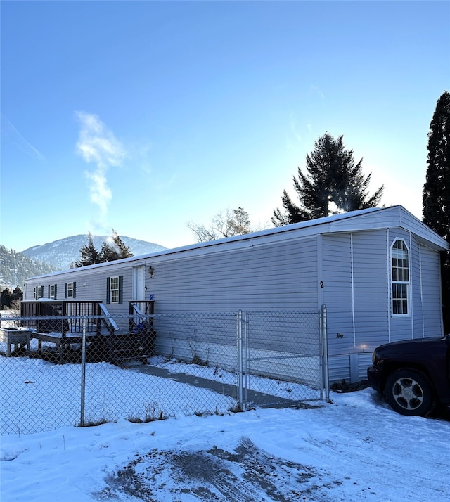 exterior space with a deck with mountain view