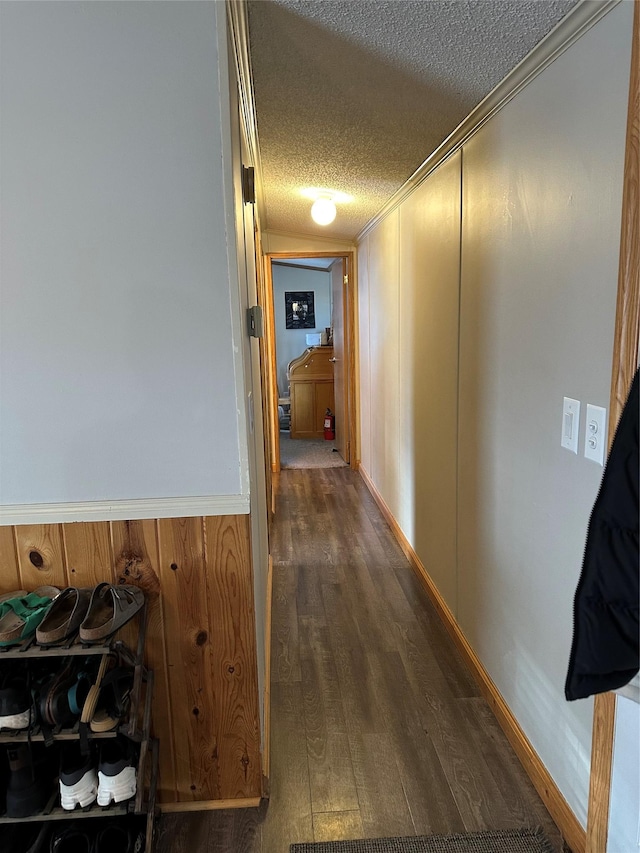 hall with dark hardwood / wood-style floors and a textured ceiling