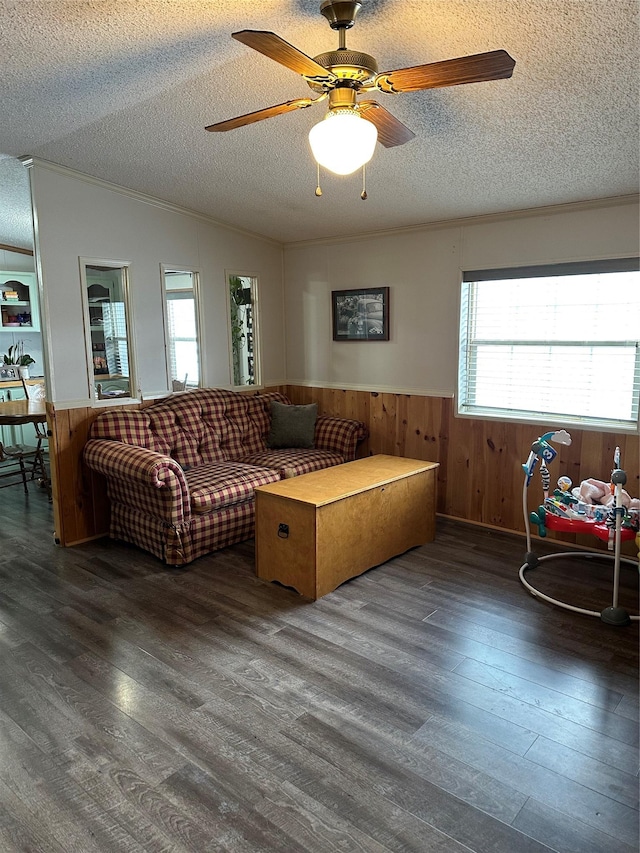 living room featuring ceiling fan, a textured ceiling, dark hardwood / wood-style flooring, vaulted ceiling, and wood walls