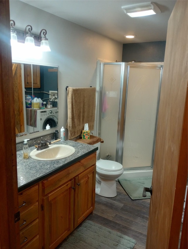 bathroom with wood-type flooring, toilet, vanity, and walk in shower