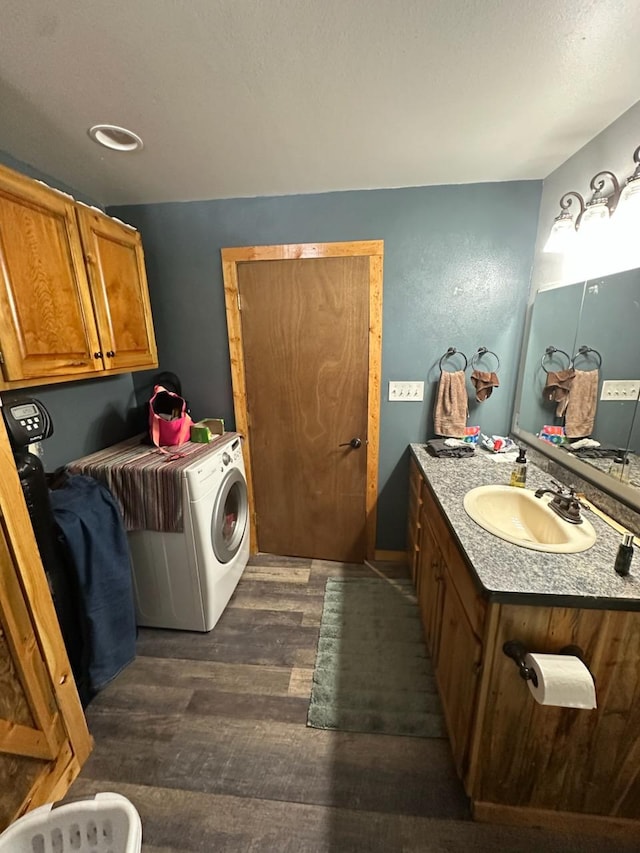 bathroom with vanity, washer / dryer, and hardwood / wood-style floors