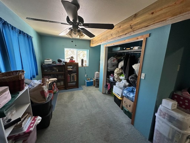 interior space featuring ceiling fan, a closet, and a textured ceiling