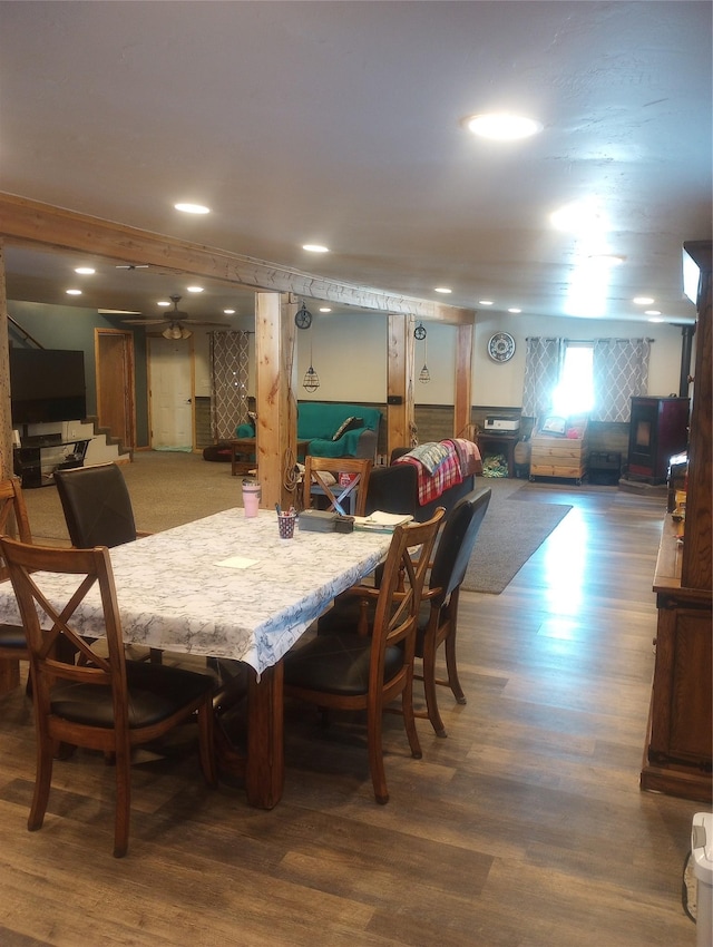 dining room featuring a wood stove and dark hardwood / wood-style flooring