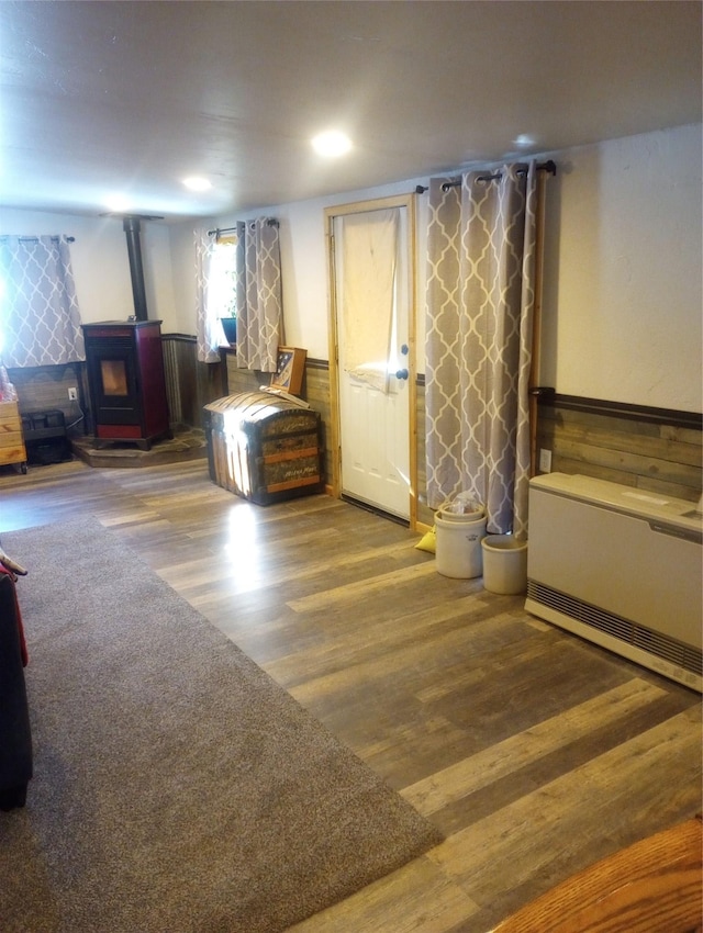 interior space featuring wood-type flooring and a wood stove