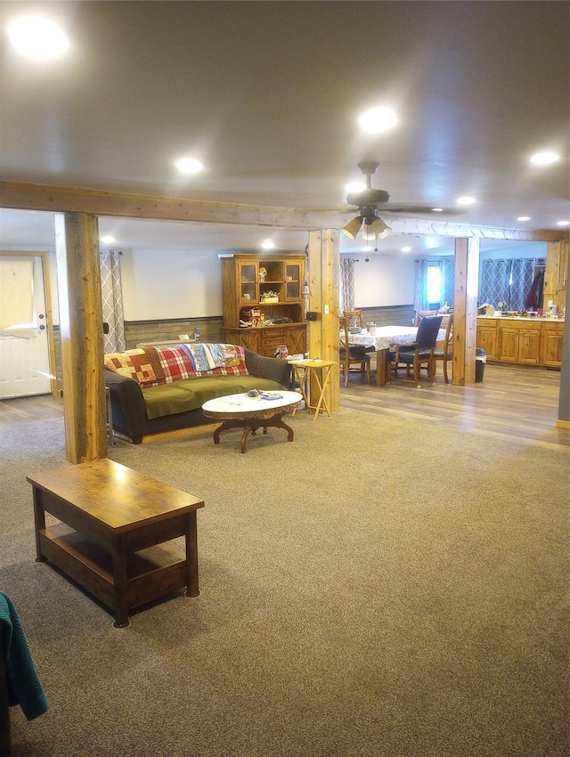 carpeted living room with ceiling fan