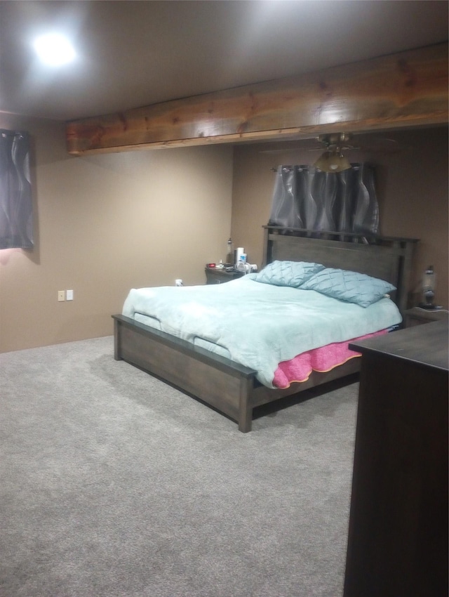 carpeted bedroom with beam ceiling