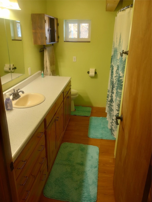 bathroom with vanity, hardwood / wood-style floors, and toilet