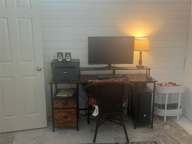 office space with concrete flooring and wood walls