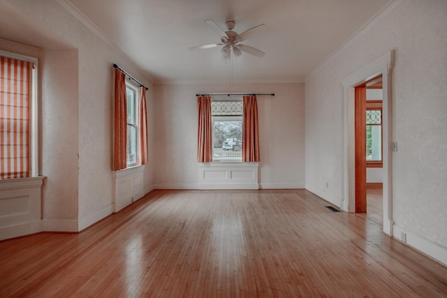 empty room with crown molding, ceiling fan, and light hardwood / wood-style floors